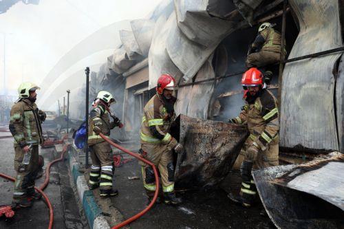 epa12701675 Firefighters try to control the fire at the Jannat shopping market in western Tehran, Iran, 03 February 2026. The cause of the fire is unclear.  EPA/ABEDIN TAHERKENAREH