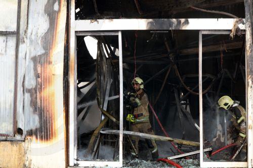 epa12701677 Firefighters try to control the fire at the Jannat shopping market in western Tehran, Iran, 03 February 2026. The cause of the fire is unclear.  EPA/ABEDIN TAHERKENAREH
