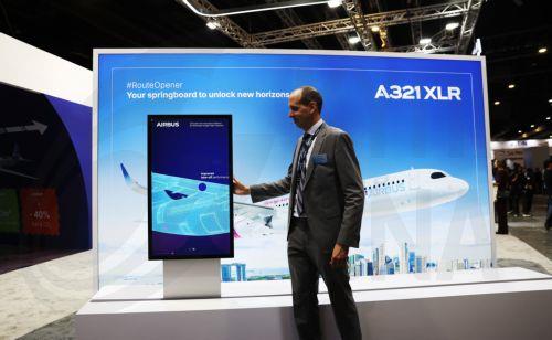 epa12701926 An Airbus employee moves an interactive display showing the A321 XLR aircraft at the Airbus exhibition booth showing the interior of the A350F freighter during the Singapore Airshow at Changi Exhibition Centre, Singapore, 03 February 2026. The Singapore Airshow 2026, one of Asia’s largest aerospace and defense exhibitions, runs from 03 to 08...