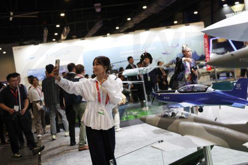 epa12701936 A visitor takes a selfie at the Aviation Industry Corporation of China (AVIC) and China National Aero-Technology Import & Export Corporation (CATIC) exhibition booth during the Singapore Airshow at Changi Exhibition Centre, Singapore, 03 February 2026. The Singapore Airshow 2026, one of Asia’s largest aerospace and defense exhibitions, runs from...