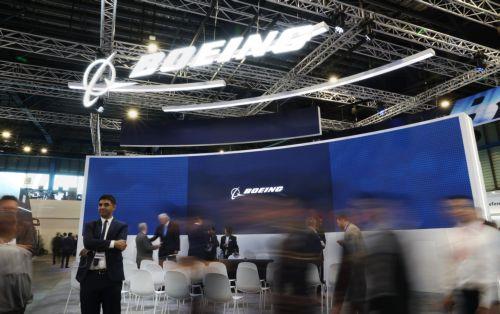 epa12701939 Visitors walk past a Boeing exhibition booth during the Singapore Airshow at Changi Exhibition Centre, Singapore, 03 February 2026. The Singapore Airshow 2026, one of Asia’s largest aerospace and defense exhibitions, runs from 03 to 08 February.  EPA/HOW HWEE YOUNG