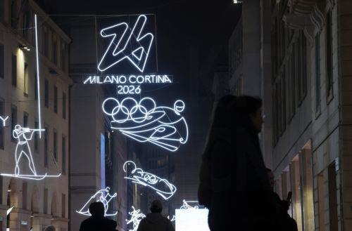epa12703653 Illuminated pictograms representing various disciplines are displayed in front of the Milan Cathedral in Milan, Italy, 03 February 2026, three days ahead of the 06 to 22 February Milan-Cortina Winter Olympics.  EPA/YONHAP SOUTH KOREA OUT