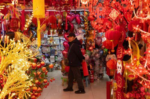 epa12719315 A person browses decorations on sale amid preparations for the Chinese New Year in Beijing, China, 09 February 2026. The Chinese New Year, or Spring Festival, begins on 17 February, ushering in the Year of the Fire Horse with festivities running until the Lantern Festival on 03 March.  EPA/JESSICA LEE
