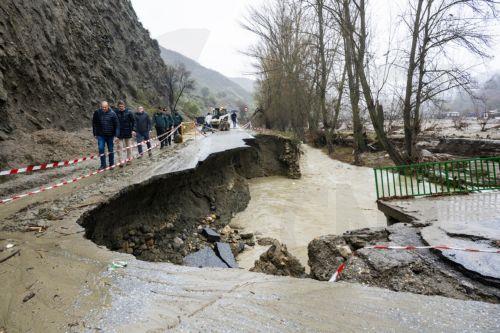 epa12723248 People look at a damaged road caused by flooding due to storms Leonardo and Marta in Duda, Granada, Spain, 10 February 2026.  EPA/MIGUEL ANGEL MOLINA