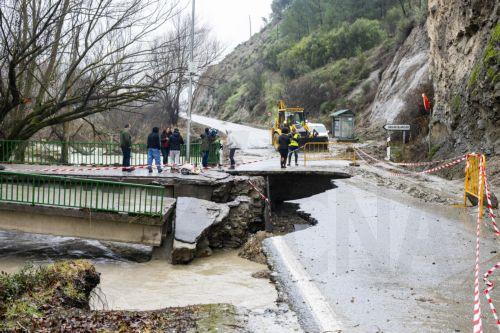 epa12723249 People look at a damaged road caused by flooding due to storms Leonardo and Marta in Duda, Granada, Spain, 10 February 2026.  EPA/MIGUEL ANGEL MOLINA