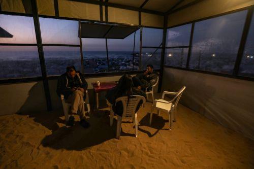 epa12725548 Internally displaced Palestinians spend their time at the coffee shop next to the beach in Gaza City, Gaza Strip, 10 February 2026. A severe fuel shortage has forced residents to burn plastic waste as an alternative source of heat and energy, despite the toxic smoke it produces. The United Nations warns that the fuel crisis has reached an...