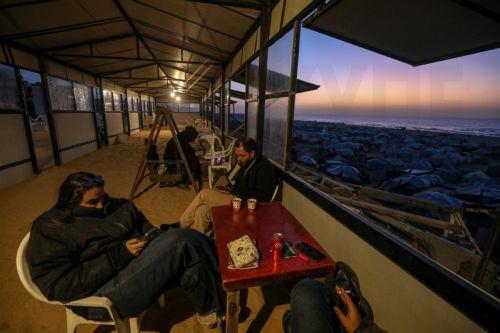 epa12725551 Internally displaced Palestinians spend their time at the coffee shop next to the beach in Gaza City, Gaza Strip, 10 February 2026. A severe fuel shortage has forced residents to burn plastic waste as an alternative source of heat and energy, despite the toxic smoke it produces. The United Nations warns that the fuel crisis has reached an...