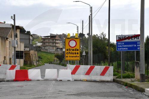 epa12747335 A damaged road is closed to the traffic in the aftermath of a landslide in the town of Niscemi, Sicily, Italy, 16 February 2026. Niscemi has been devastated by a major landslide that occurred in late January 2026, triggered by Storm Harry that swept across Sicily and southern Italy.  EPA/ORIETTA SCARDINO