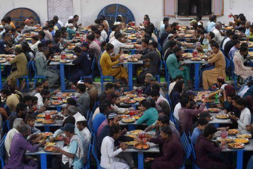 epa12758087 Pakistani people eat Iftar meals during the first day of the holy fasting month of Ramadan in Karachi, Pakistan, 19 February 2026. The Muslims' holy month of Ramadan, which start this year on 19 February in Pakistan, is the ninth month in the Islamic calendar, and it is believed that the revelation of the first verse in the Koran was during its...