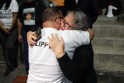 epa12770606 Lewis Jose Mendoza (L), the political leader of Vente Venezuela, embraces his mother upon release from the Bolivarian National Police headquarters in La Yaguara, Caracas, Venezuela, 22 February 2026.  EPA/Ronald Pena R
