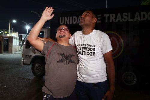 epa12770608 Lewis Mendoza (L), the political leader of Vente Venezuela, reacts alongside his friend Guillermo Lopez (R) upon release from the Bolivarian National Police headquarters in La Yaguara, Caracas, Venezuela, 22 February 2026.  EPA/Ronald Pena R
