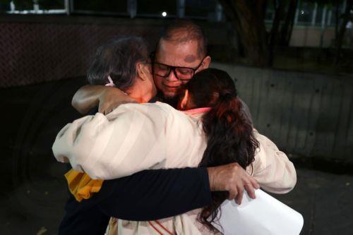 epa12770609 Lewis Jose Mendoza (2-R), the political leader of Vente Venezuela, embraces his mother and wife upon release from the Bolivarian National Police headquarters in La Yaguara, Caracas, Venezuela, 22 February 2026.  EPA/Ronald Pena R