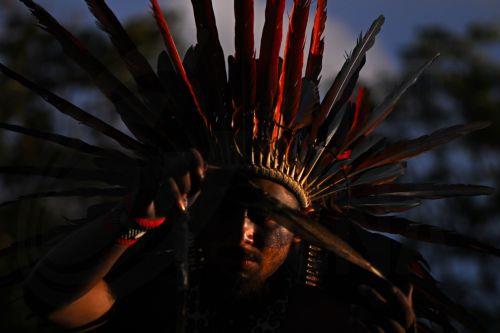 epa12774771 An indigenous person celebrates after the Brazilian government repeals Decree 12600 in front of the Planalto Palace in Brasilia, Brazil, 24 February 2026. The decree had authorized concessions for the construction of three waterways in the Amazon and sparked protests from indigenous groups concerned about the effects of river dredging on their...