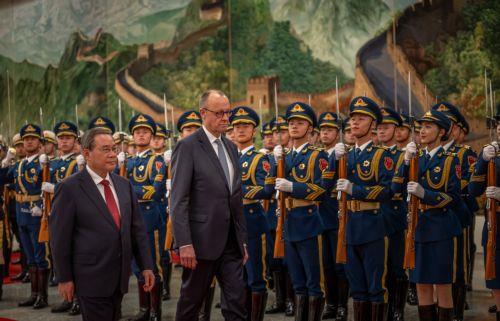 epa12775434 Chancellor of Germany Friedrich Merz (2-L) is welcomed with military honors at the Great Hall of the People by Li Qiang (L), Premier of China, in Beijing, China, 25 February 2026. Merz is visiting China for the first time as Chancellor.  EPA/Michael Kappeler / POOL