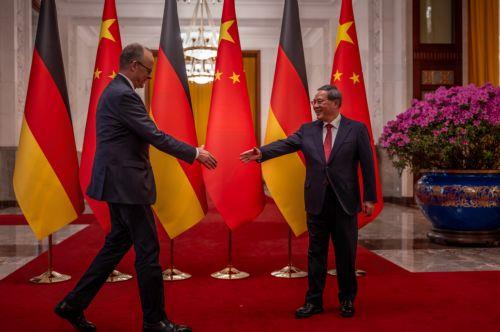 epa12775437 Chancellor of Germany Friedrich Merz (L) and Premier of China Li Qiang approach to shake hands at the Great Hall of the People in Beijing, China, 25 February 2026. Merz is visiting China for the first time as Chancellor.  EPA/Michael Kappeler / POOL Pool alle Agenturen