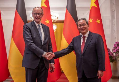 epa12775438 Chancellor of Germany Friedrich Merz (L) and Premier of China Li Qiang shake hands at the Great Hall of the People in Beijing, China, 25 February 2026. Merz is visiting China for the first time as Chancellor.  EPA/Michael Kappeler / POOL