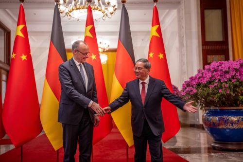 epa12775439 Chancellor of Germany Friedrich Merz (L) and Premier of China Li Qiang shake hands at the Great Hall of the People in Beijing, China, 25 February 2026. Merz is visiting China for the first time as Chancellor.  EPA/Michael Kappeler / POOL