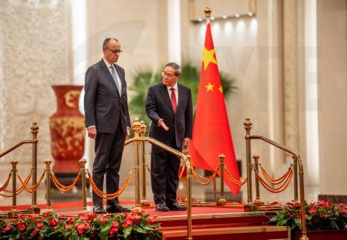 epa12775442 Chancellor of Germany Friedrich Merz (L) and Premier of China Li Qiang take part in a ceremony at the Great Hall of the People in Beijing, China, 25 February 2026. Merz is visiting China for the first time as Chancellor.  EPA/Michael Kappeler / POOL