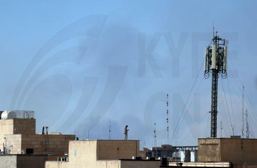 epaselect epa12786537 An Iranian man watches as smoke rises in central Tehran after an Israeli attack in Iran, 01 March 2026. A joint Israeli and US military operation continues on its second day after targeting multiple locations across Iran in the early hours of 28 February 2026, with Iran later launching retaliatory attacks.  EPA/ABEDIN TAHERKENAREH