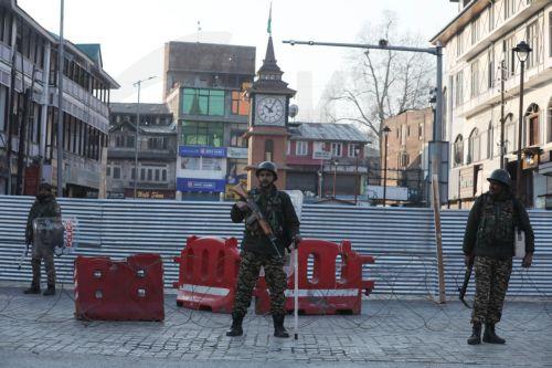 epa12788728 Indian paramilitary personnel stand guard behind barbed wire and barricades near the sealed city centre at Lal Chowk during restrictions in Srinagar, Kashmir, India, 02 March 2026. The authorities imposed severe restrictions a day after Shia Muslim demonstrators staged massive protests and assembled in the city centre near the iconic clock tower...