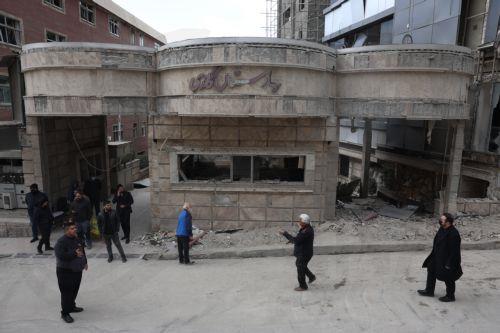 epaselect epa12789134 People gather at the gate of the destroyed Gandhi hospital in Tehran, Iran, 02 March 2026. Gandhi hospital was hit in Israeli airstrikes on 01 March. A joint Israeli-US military operation targets multiple locations across Iran since the early hours of 28 February 2026.  EPA/ABEDIN TAHERKENAREH