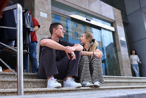 epa12789642 A Polish couple, stranded due to suspended air traffic, waits in front of a hotel in Doha, Qatar, 02 March 2026. Following a joint Israel-US military operation targeting multiple locations across Iran in the early hours of 28 February 2026 and Iran's retaliatory attacks across the region, several countries closed their airspace and airlines...