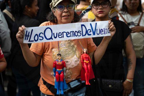 epa12793163 A person holds a sign that reads '#WeWantThemBack' (#LosQueremosDeVuelta) during a march in Caracas, Venezuela, 03 March 2026. Hundreds of Chavistas march to demand the release of Nicolas Maduro and his wife Cilia Flores two months after their capture by US military forces following an attack on Caracas and three nearby regions.  EPA/Ronald Peña...