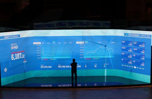 epa12793745 A man follows the stock market shares on a screen with stock information at the Dubai Financial Market (DFM) in the Gulf emirate of Dubai, United Arab Emirates, 04 March 2026. The Dubai Financial Market has reopened with other Emirates markets resuming trading across the UAE after two days of closure amid heightened military tensions following...