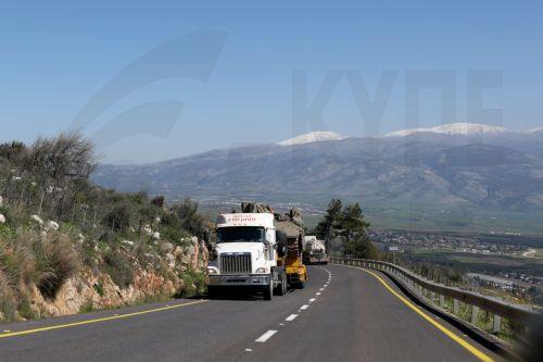 epa12797148 Heavy transport trucks carry Israeli tanks along a road near the Lebanon border in Upper Galilee, northern Israel, 05 March 2026. The Israeli military stated it is conducting strikes across Lebanon targeting Hezbollah infrastructure and personnel.  EPA/ATEF SAFADI