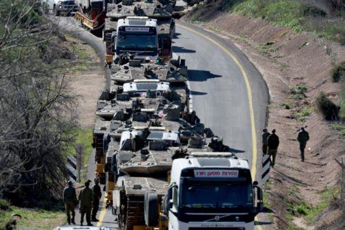 epaselect epa12797145 Heavy transport trucks carry Israeli tanks along a road near the Lebanon border in Upper Galilee, northern Israel, 05 March 2026. The Israeli military stated it is conducting strikes across Lebanon targeting Hezbollah infrastructure and personnel.  EPA/ATEF SAFADI
