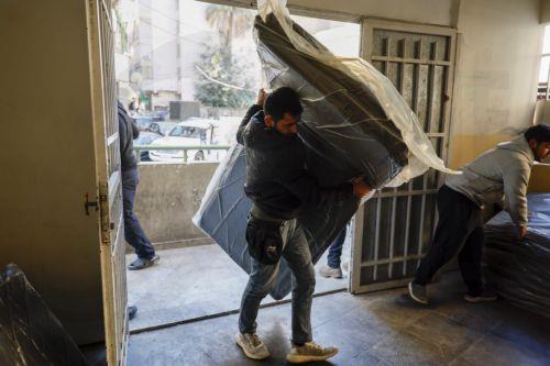 epa12805918 A volunteer carries blankets for displaced residents in a local school used as a shelter in Beirut, Lebanon, 09 March 2026, after fleeing their homes in southern Lebanon following Israeli airstrikes. The Israeli military stated it is conducting strikes across the country targeting Hezbollah infrastructure and personnel. According to the Disaster...