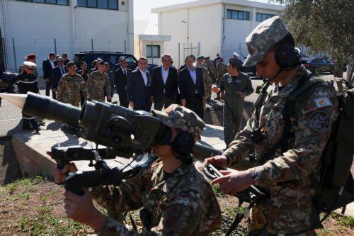 epa12806508 French President Emmanuel Macron (C-L), Cypriot President Nikos Christodoulides (C-R), and Greek Prime Minister Kyriakos Mitsotakis (C) watch members of the military at Paphos military airport, in Paphos, Cyprus, 09 March 2026, on the day of Macron's visit to show France's solidarity after recent drone attacks amid the U.S.-Israeli conflict with...