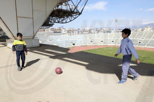 epa12811744 Displaced boys play football inside the Camille Chamoun Sports City Stadium in Beirut, Lebanon, 11 March 2026. Lebanese authorities report more than 759,000 registered displaced since the escalation began on 02 March 2026, though the true number is likely higher as many stay with relatives or rent in safer areas.  EPA/WAEL HAMZEH