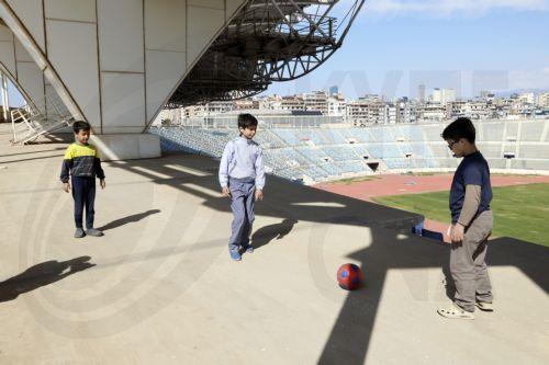 epa12811745 Displaced boys play football inside the Camille Chamoun Sports City Stadium in Beirut, Lebanon, 11 March 2026. Lebanese authorities report more than 759,000 registered displaced since the escalation began on 02 March 2026, though the true number is likely higher as many stay with relatives or rent in safer areas.  EPA/WAEL HAMZEH