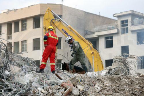 epaselect epa12813904 Iranian rescue workers work among the rubble of damaged residential buildings in central Tehran, Iran, 12 March 2026. A joint Israeli and US military operation continues to target multiple locations across Iran since the early hours of 28 February 2026.  EPA/ABEDIN TAHERKENAREH