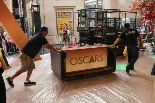 epa12815920 Workers assemble parts of the red carpet backdrop as preparations for the 98th annual Academy Awards ceremony get underway in Los Angeles, California, USA, 12 March 2026. The 98th Academy Awards ceremony will take place at the Dolby Theatre in Los Angeles on 15 March 2026.  EPA/CHRIS TORRES