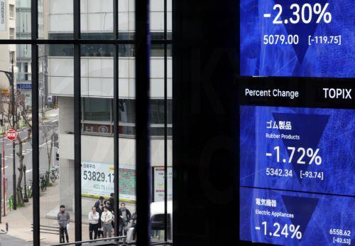 epa12816146 Passersby stand before a stock market indicator board in Tokyo, Japan, 13 March 2026. The Nikkei Stock Average continued to fall, at one point dropping more than 1,100 points from the previous day. Investors sentiment worsened following the surge of crude oil prices amid the Middle East conflict.  EPA/FRANCK ROBICHON
