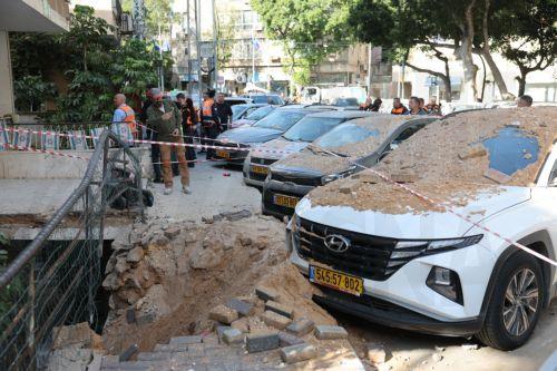 epa12821430 People stand at the site after fragments from an intercepted Iranian ballistic missile hit in Ramat Gan, Israel, 15 March 2026. The Israeli military said that it detected missiles launched from Iran following earlier US and Israeli strikes.  EPA/ABIR SULTAN