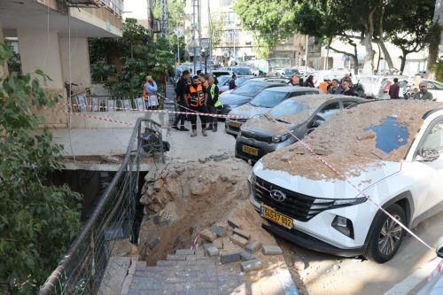 epa12821431 People stand at the site after fragments from an intercepted Iranian ballistic missile hit in Ramat Gan, Israel, 15 March 2026. The Israeli military said that it detected missiles launched from Iran following earlier US and Israeli strikes.  EPA/ABIR SULTAN