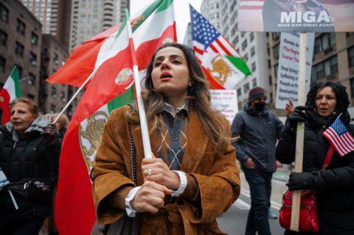 epa12823486 A woman marches with an Iranian monarchy flag during a ‘Freedom for Iran’ protest in New York, New York, USA, 15 March 2026. The rally comes amid ongoing hostilities involving the United States, Israel and Iran.  EPA/OLGA FEDOROVA
