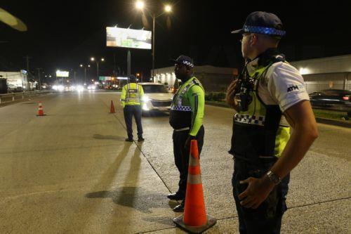 epa12824589 Members of the Guayaquil Transit and Mobility Authority (ATM) stand guard on a street after the imposition of curfew in Guayaquil, Ecuador, 15 March 2026. The nighttime curfew decreed by Ecuadorian President Daniel Noboa in four provinces began with the deployment of more than 75,000 soldiers and police officers to intensify the 'war' declared...