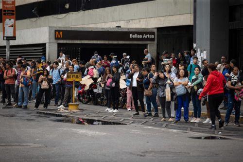 epa12826411 People wait at a bus stop during a transportation strike in Caracas, Venezuela, 16 March 2026. Venezuela’s acting president, Delcy Rodriguez, denounced an attempt to shut down transportation in capital after members of the sector called for a strike to demand an increase in the minimum fare.  EPA/Ronald Pena R