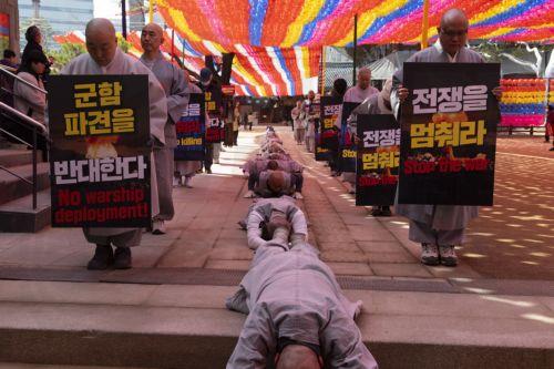 epa12826563 South Korean monks perform the Buddhist praying act of Dharna - walking three steps and making one bow - toward the US Embassy during a protest against US President Trump, in Seoul, South Korea, 17 March 2026. Protesters gathered to oppose Trump’s request for South Korea to send ships to the Strait of Hormuz.  EPA/JEON HEON-KYUN